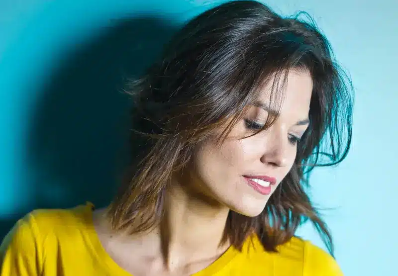 Donna con maglietta gialla, di profilo, con un bel naso | LaserMilano